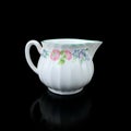 Antique milk jug with floral pattern. Royalty Free Stock Photo