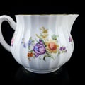 Antique milk jug with floral pattern. Royalty Free Stock Photo