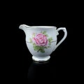 Antique milk jug with floral pattern. Royalty Free Stock Photo