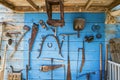 Antique miner\'s tools displayed on a blue wall