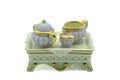 Antique miniature bone china tea set with tiny tea pot milk and sugar bowl on a serving tray also made from bone china or