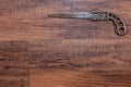 Antique miniature metal saw on a hardwood workbench - top right