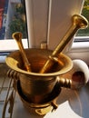 Antique mortar and accessory at window Royalty Free Stock Photo
