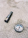 Antique nautical telescope and old metal compass on texture mesh net surface