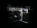 Antique obsolete russian or soviet professional dslr camera with film from ussr, retro photography equipment in darkness against