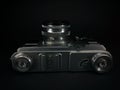 Antique obsolete russian or soviet professional dslr camera with film from ussr, retro photography equipment in darkness against