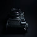 Antique obsolete russian or soviet professional dslr camera with film from ussr, retro photography equipment in darkness against