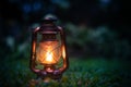 antique oil lamp On the grass in the forest in the evening camping atmosphere.Travel Outdoor Concept image Royalty Free Stock Photo