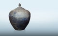 antique and old blue and black clay pot and lid on blue background, vintage, object, decor, copy space Royalty Free Stock Photo