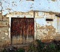 Antique old destroyed brown door from old blue house