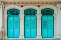 Antique old green wooden window on yellow cement wall exterior architure Royalty Free Stock Photo