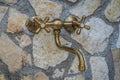 Antique old plumbing tap in a stone wall Royalty Free Stock Photo