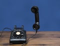 Antique old rotary dial telephone on wooden desk Royalty Free Stock Photo