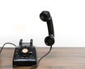 Antique old rotary dial telephone on wooden desk Royalty Free Stock Photo