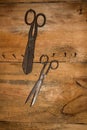 Antique old style retro object assemblage on a wooden wall scissors. Background.
