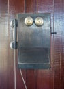 Antique old telephone hang on wooden wall Royalty Free Stock Photo