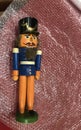 An antique old wooden German Nutcracker lies on the packing film on the left.