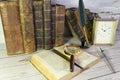 Antique open book with a magnifying glass and antique writing pen