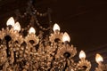 Antique ornate crystal chandelier in a darkened room, copy space