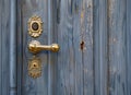 antique ornate gold door handle on a blue wall Royalty Free Stock Photo