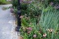 Antique ornate lamp post in New York city park with path lush garden