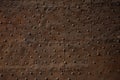 Antique oxidized metal with rivets. Rusty brown iron wall. Grunge texture or background Royalty Free Stock Photo