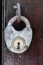 antique padlock hung on closed wooden door