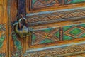 An antique padlock in the shape of a one-humped dromedary camel guards the tranquility on a beautifully decorated door