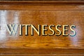 An antique painted door sign of wording in capital letters, showing where witnesses should enter. Royalty Free Stock Photo