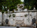 Antique park rome with columns and monuments a lot of greenery and sculptures marble