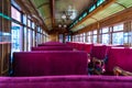 Antique passenger car interior with red louver seats