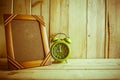 Antique photo frame and clock on wooden table over wood background Royalty Free Stock Photo