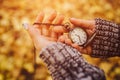 Antique pocket clock in hands on an autumn background close-up on the street Royalty Free Stock Photo