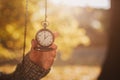 Antique pocket clock in hands on an autumn background close-up on the street Royalty Free Stock Photo