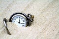 Antique pocket watch buried in sand Royalty Free Stock Photo