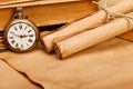 Antique pocket watch and paper rolls Royalty Free Stock Photo