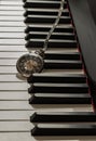 Antique pocket watch on piano keyboard. Time for music conceptual