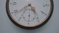 Antique pocket watch with a white dial and gold second, minute and hour hands on a light gray background. The face of an Royalty Free Stock Photo