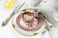 Antique porcelain breakfast setting with milk coffee on white cloth