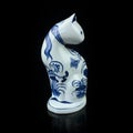 Antique porcelain figurine in the shape of a cat.