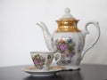 Antique porcelain teapot with cup and saucer