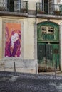 Antique Portuguese Architecture: Old Green Door and Girl Painting in a Street- Portugal Royalty Free Stock Photo