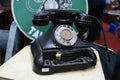 Antique pull dial round phones are on display for sale at the pawnshop.