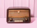 Antique radio from 50s minimal retro concept. Arrangement made against baby pink background