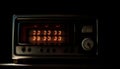 Antique radio tuner knob illuminated with nostalgia generated by AI
