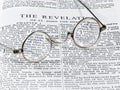 Antique reading glasses on page of bible Royalty Free Stock Photo