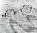 Antique reading glasses on page of bible Royalty Free Stock Photo