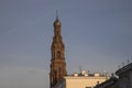 Antique red brick bell tower against the blue sky.