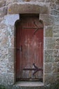 Antique red distressed door with rusty iron work stone frame beautiful european travel