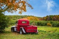 Antique red farm truck in autumn apple orchard Royalty Free Stock Photo